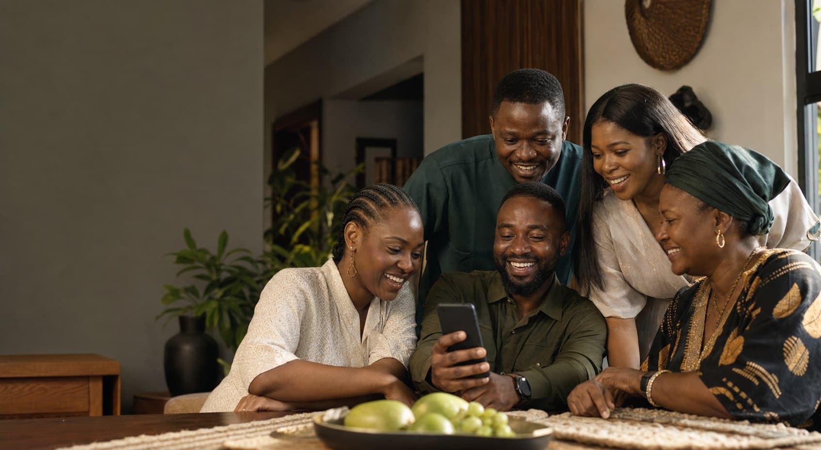 Campaign artwork of a Nigerian family and friends circle looking at a phone together